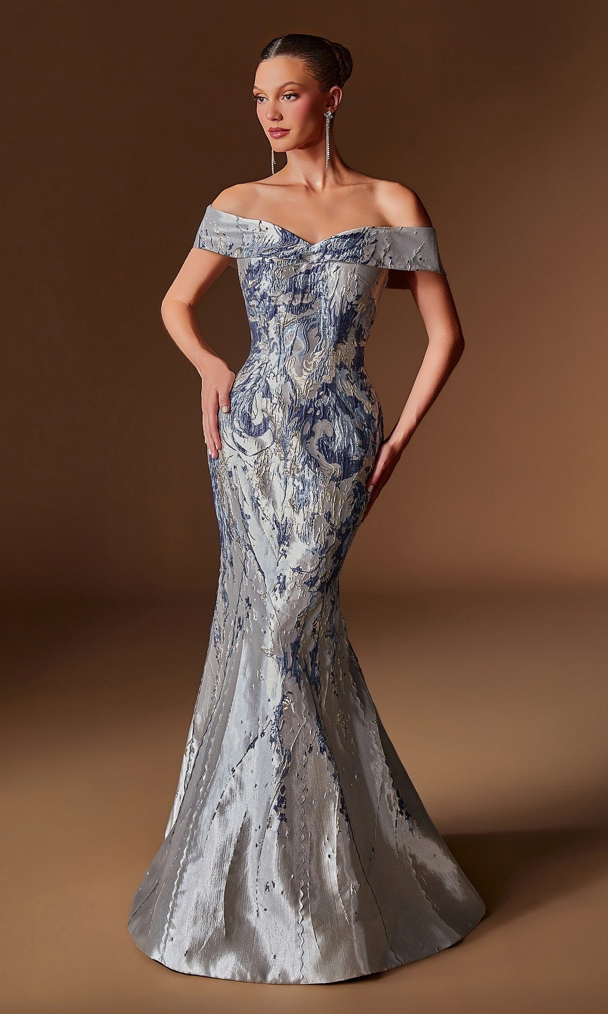 A woman stands against a plain brown background wearing the Ladivine CD0107 Long Formal Dress in navy, featuring an off-the-shoulder fitted bodice, flared skirt, and a subtle textured jacquard design.